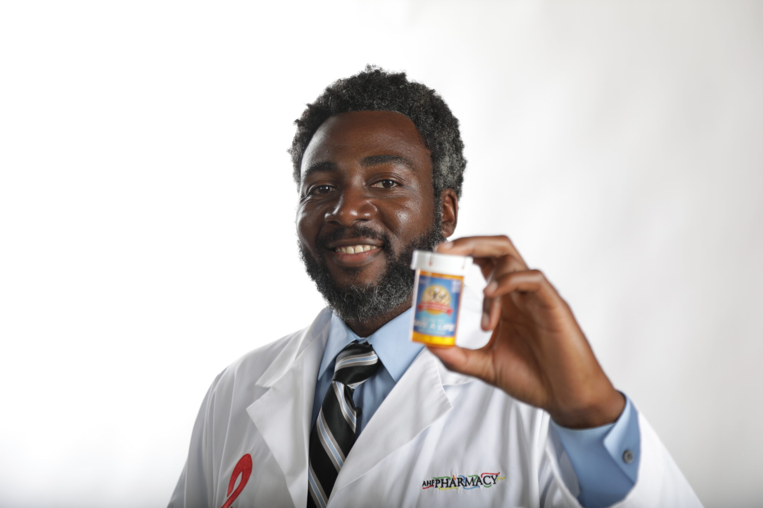 AHF Doctor holding medications in front of a white background