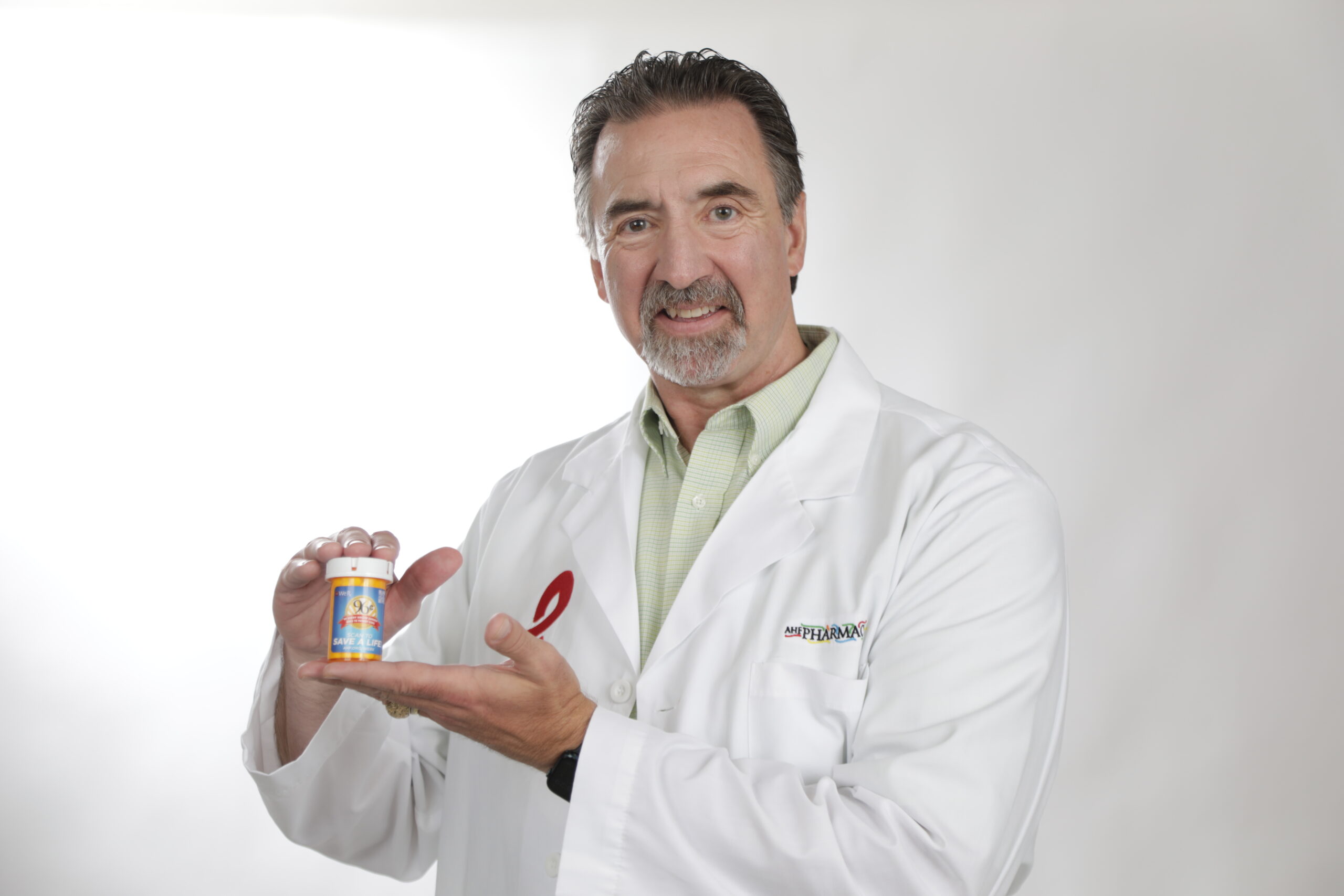 AHF Doctor holding medication